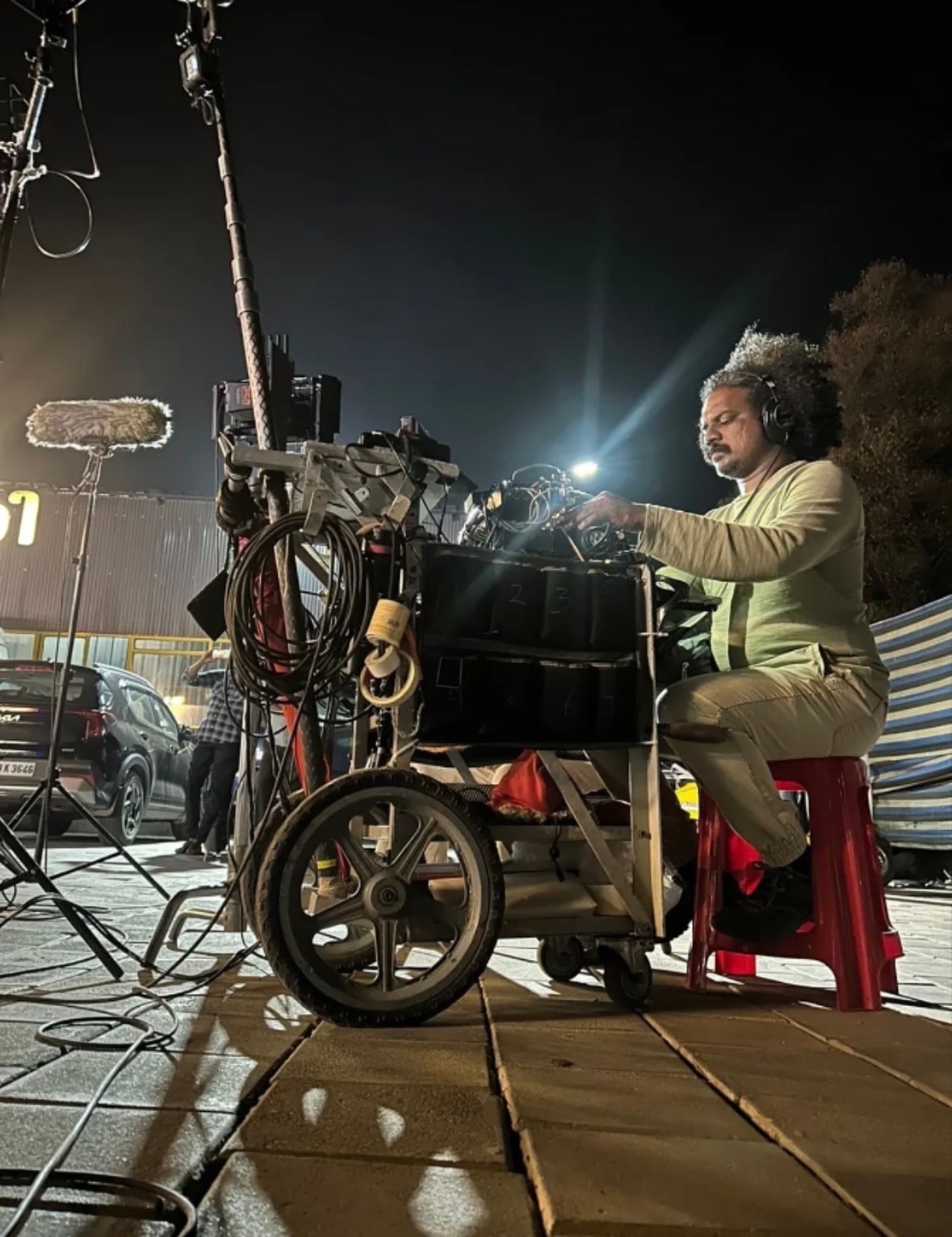SyncLab sound engineer at production cart on night film set
